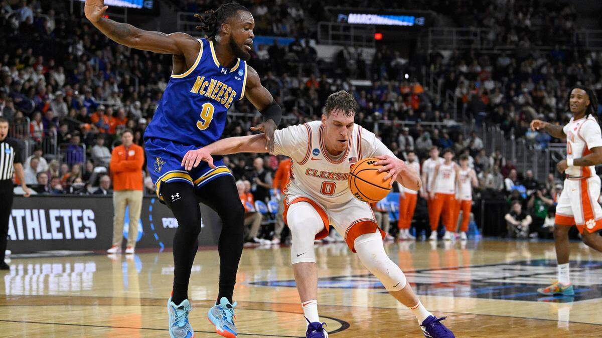 Mar 20, 2025; Providence, RI, USA; Clemson Tigers center Viktor Lakhin (0) drives against McNeese State Cowboys forward Bryant Selebangue (9) during the first half at Amica Mutual Pavilion