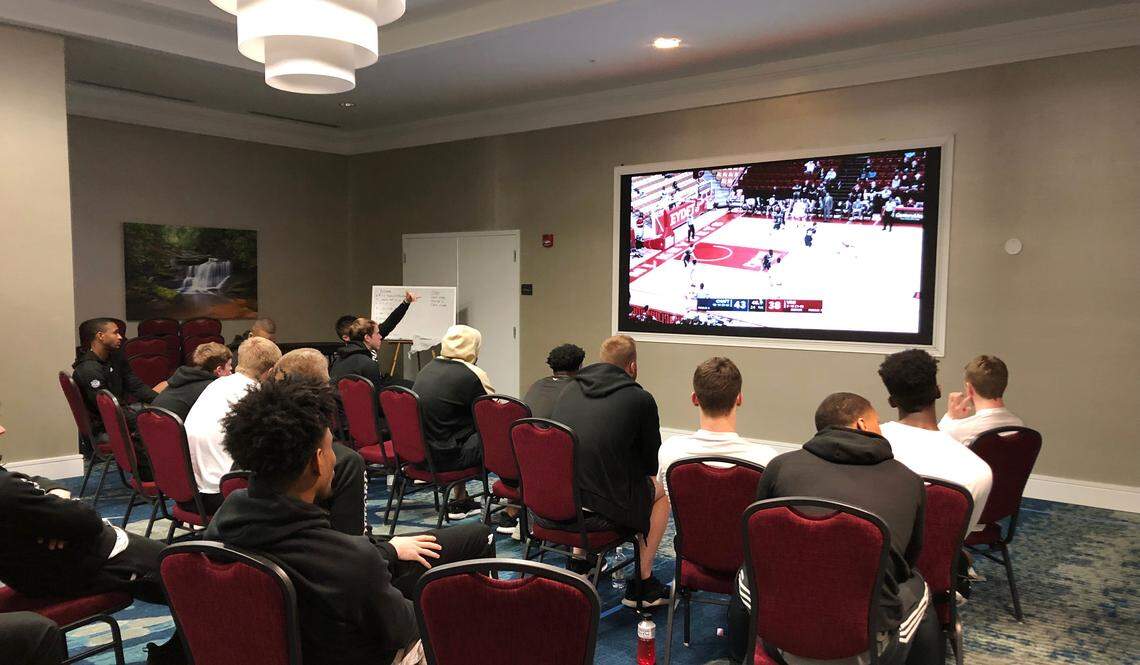 Wofford’s basketball team watches film inside a hotel ballroom ahead of the Southern Conference Tournament.