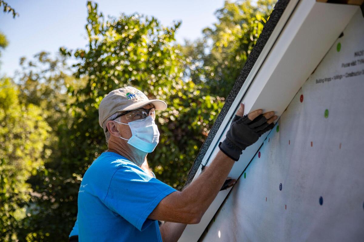 Mike Sullivan installs flashing on a home in Cayce, South Carolina on Thursday, October 1, 2020. Sullivan has volunteered with Habitat for Humanity for twenty years.