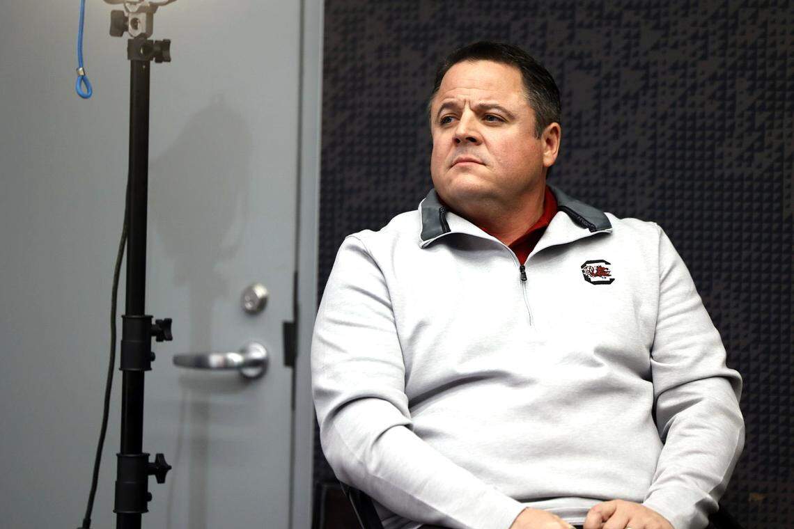 Dowell Loggains looks on as Shane Beamer discusses his hire as South Carolina’s offensive coordinator.