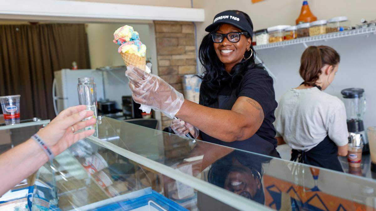 Sonia Norman serves a cone at IceCream Taco in Lexington. The new ice cream parlor and cafe opened in March.