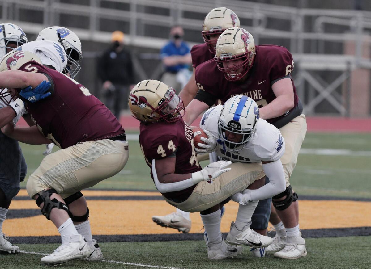 Erskine College’s Dearius Hazel 44 is taken down by Shorter University’s Hunter Poole 10 on Saturday, March 13, 2021.