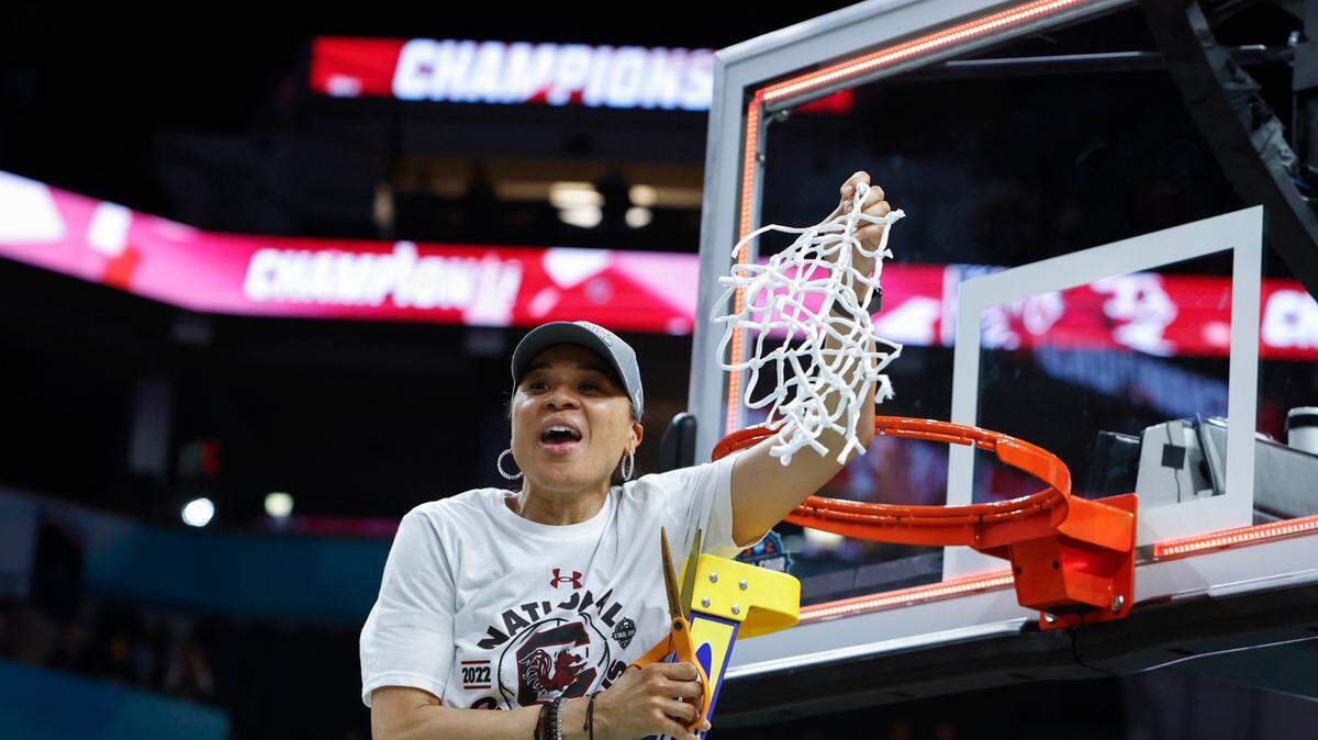 University of South Carolina Head Coach Dawn Staley celebrates with the net after winning the national championship against UConn at the Target Center in Minneapolis, Minn. on Sunday April 3, 2022.