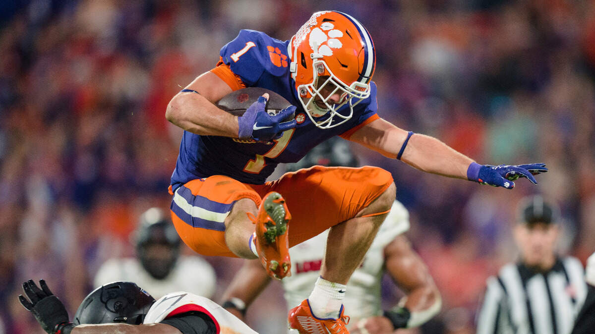 Clemson running back Will Shipley (1) hurdles over Louisville safety M.J. Griffin (26) on his way to a touchdown in the second half of an NCAA college football game, Saturday, Nov. 12, 2022, in Clemson, S.C.