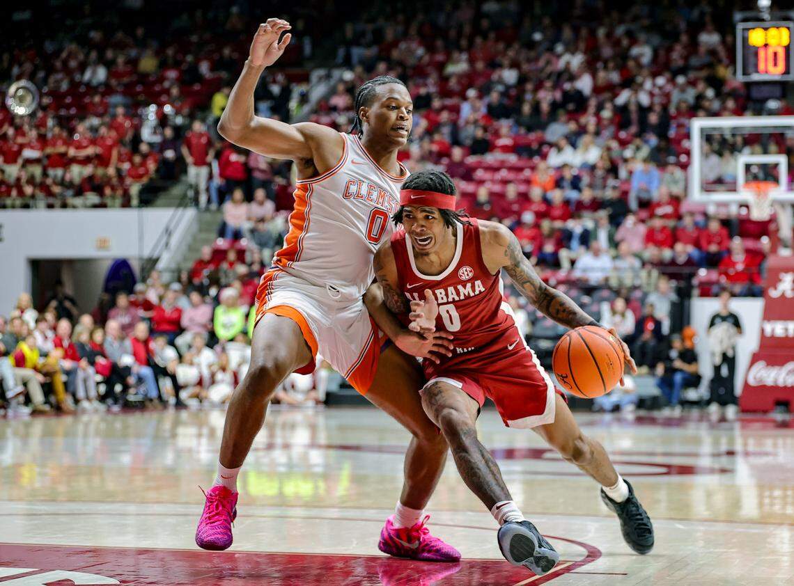 Labaron Philon, right, of the Alabama Crimson Tide drives to the basket during the second half against RJ Godfrey of the Clemson Tigers at Coleman Coliseum on Dec. 3, 2025 in Tuscaloosa, Alabama.