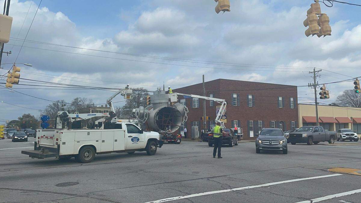 The “Busted Plug” fire hydrant sculpture is moved from its longtime spot on Taylor Street on Thursday, Feb. 23