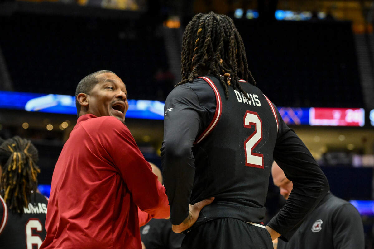 South Carolina Gamecocks head coach Lamont Paris talks with guard Zachary Davis (2) during a time out against the Arkansas Razorbacks during the first half at Bridgestone Arena.
