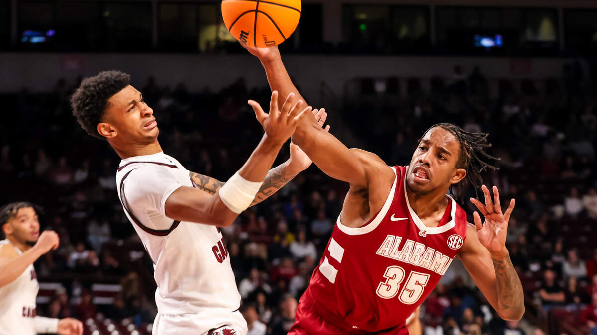 Jan 8, 2025; Columbia, South Carolina, USA; South Carolina Gamecocks guard Arden Conyers (21) and Alabama Crimson Tide forward Derrion Reid (35) battle for a rebound in the second half at Colonial Life Arena. Mandatory Credit: Jeff Blake-Imagn Images