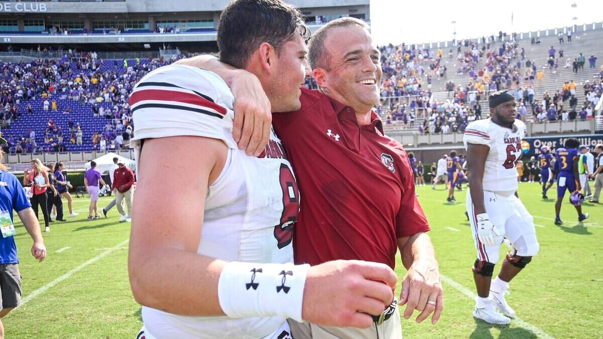 South Carolina football coach Shane Beamer with QB Zeb Noland after the 2021 game at East Carolina.