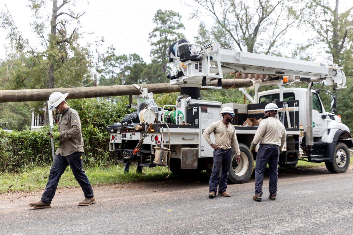 Utility crews with Aiken Electric Cooperative, prepare to move to their next site while repairing downed power lines on Lanford Road in Edgefield on Tuesday, Oct. 1, 2024. High winds from Hurricane Helene toppled trees leaving thousands without power. The damage to rural areas is so bad that along many roads, the entire electrical infrastructure needs to be rebuilt.