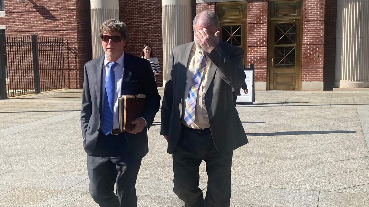 Thomas Bateman Jr., right, was sentenced to two years in federal prison for his role in a scheme to get a woman to change her $20 million will so he and a friend could inherit her money.