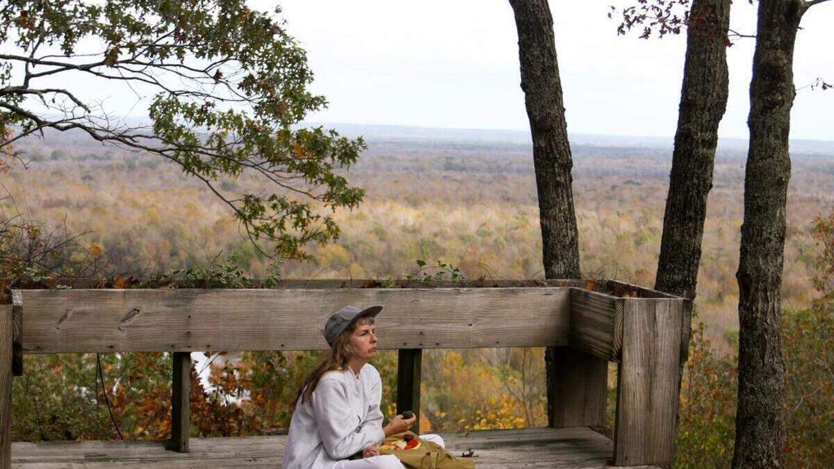 The Wateree River Heritage Preserve includes Cook's Mountain, an unusually tall land formation in the flat Midlands area of South Carolina. Negotiations are underway to expand the 3,700-acre preserve by 736 acres with acquisition of historic plantation land. In this November 2015 photo, Katherine Boyle, a state employee, enjoys the lookout at Cook's Mountain.  (11/18/15)