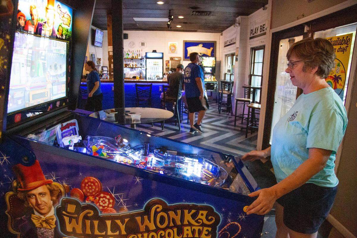 Fran Owens plays pinball at Bang Back Pinball Lounge in Five Points on Thursday, July 15, 2021. The bar often hosts women’s pinball tournaments.