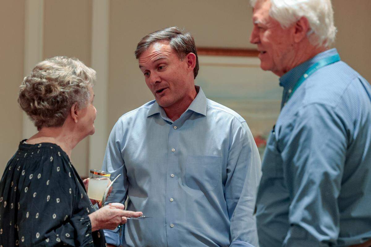 Russell Ott speaks with Gladys Robertson and Jim Smith at a gathering at Still Hopes on Tuesday, Oct. 15, 2024.