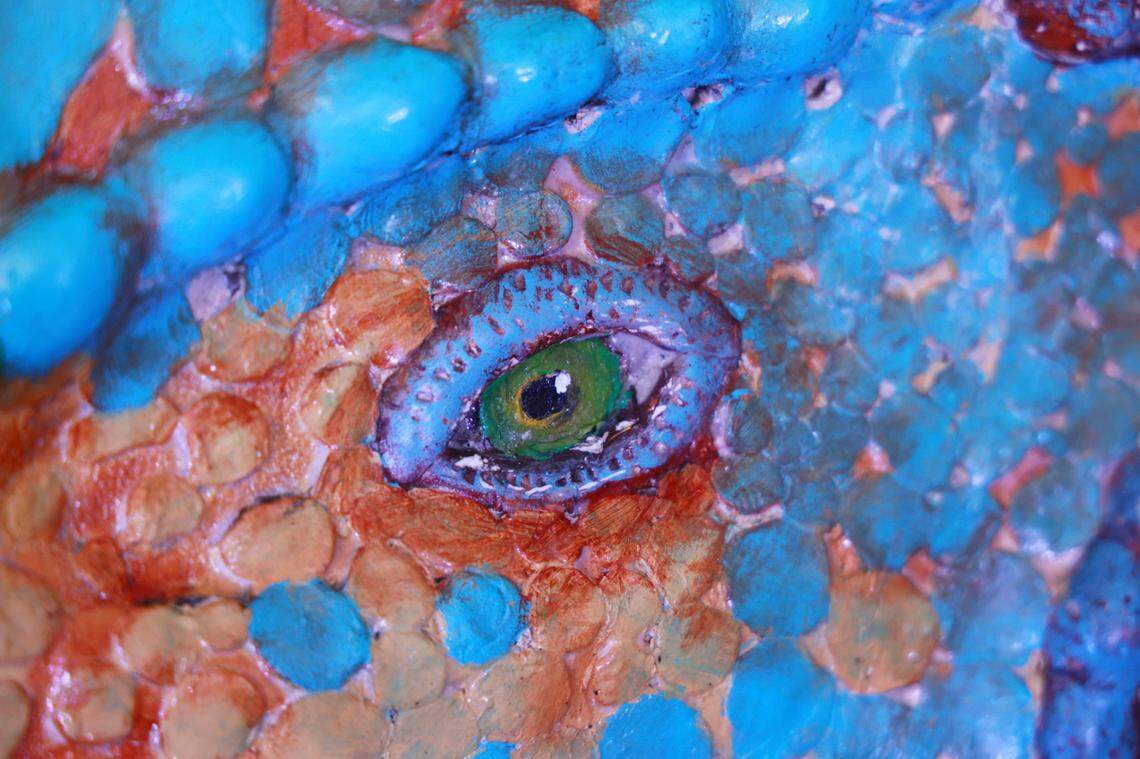 Christopher Price shows dinosaurs he made out of insulation foam outside his home on Wednesday, December 11, 2024. The dinosaurs are visible from Augusta Road in Lexington, South Carolina