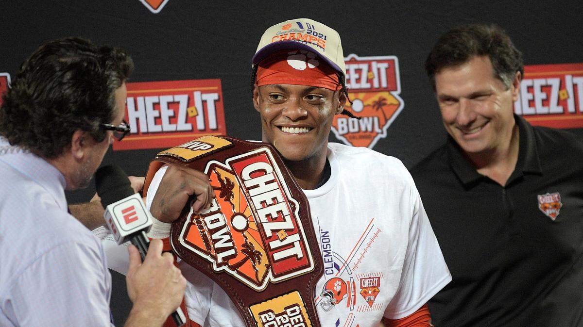 Clemson cornerback Mario Goodrich, center, is interviewed by ESPN’s Tom Luginbill, left, after being named the MVP of the Cheez-It Bowl NCAA college football game against Iowa State, Wednesday, Dec. 29, 2021, in Orlando, Fla. (AP Photo/Phelan M. Ebenhack)