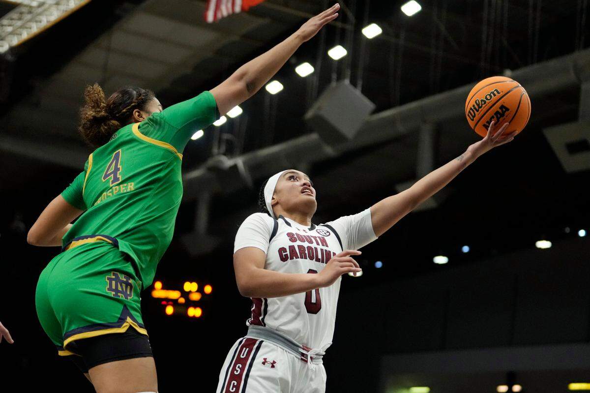 South Carolina guard Te-Hina Paopao (0) drives past Notre Dame guard Cassandre Prosper (4) during the first half of an NCAA college basketball game Monday, Nov. 6, 2023, in Paris. (AP Photo/Thibault Camus)