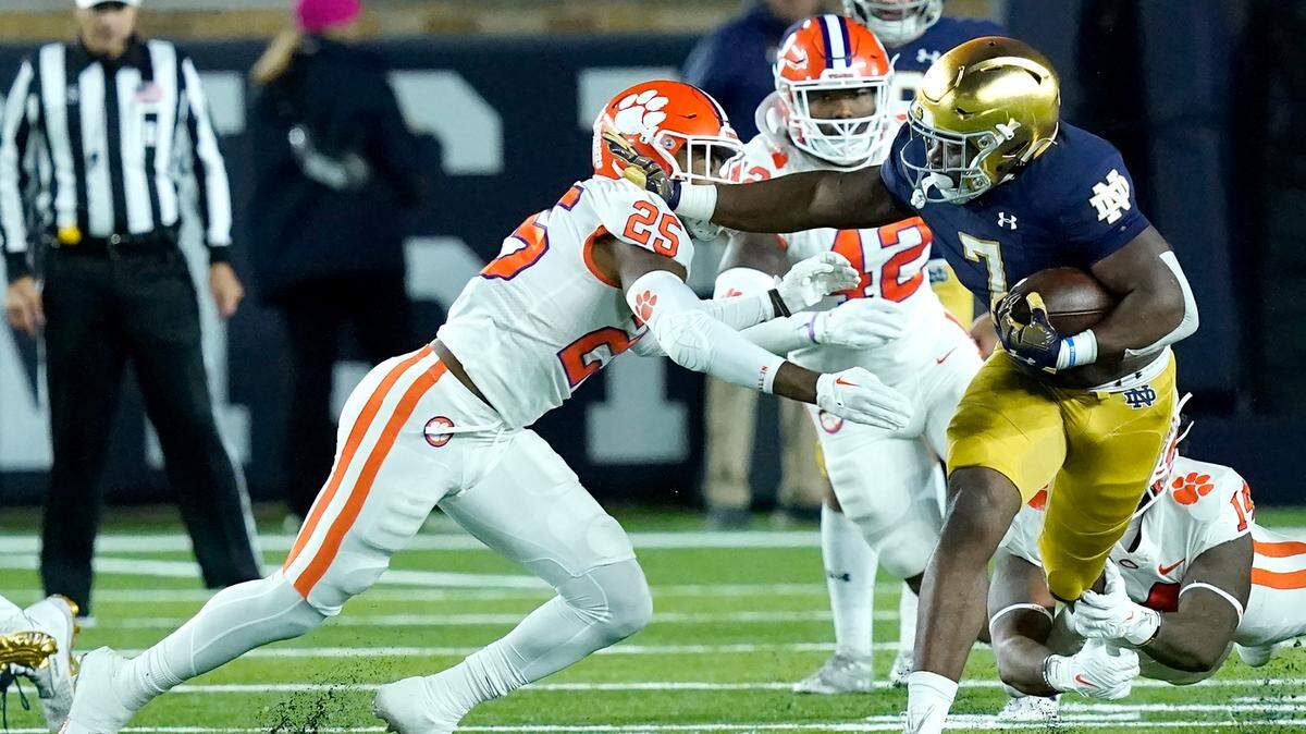 Notre Dame running back Audric Estime (7) carries the ball as Clemson safety Jalyn Phillips comes up to make the tackle during the first half of an NCAA college football game Saturday, Nov. 5, 2022, in South Bend, Ind. (AP Photo/Charles Rex Arbogast)