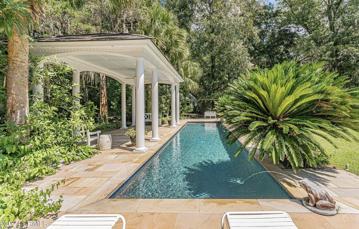 A pool is among the other outside amenities at Dean Hall, including six habitable structures with barns, a four-car garage, sheds, shop, accessory structures, gardens, a potting shed, ponds and gathering centers.