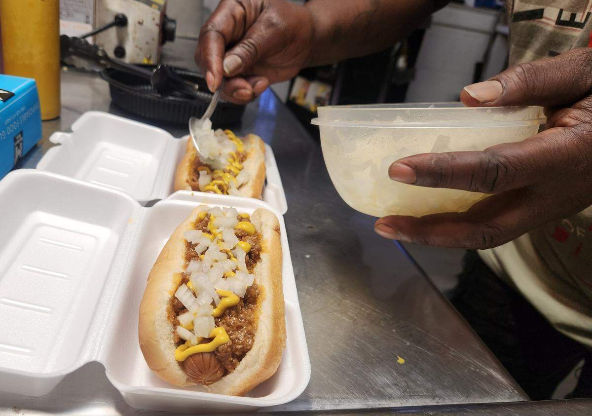 Ben Chestnut spoons onions onto hot dogs at B&S One Stop at 1823 Superior St. in Columbia. B&S recently won The State’s 2025 Hot Dog Poll.