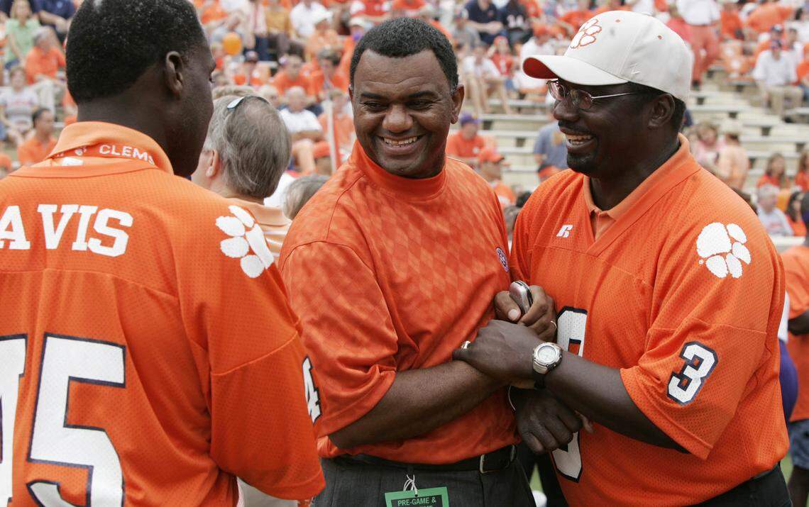 Former Clemson football players, from left, Jeff Davis, Perry Tuttle and Homer Jordan (3) greet each other as they meet for a special ceremony for to honor the 1981 national championship team Sept. 23, 2006.