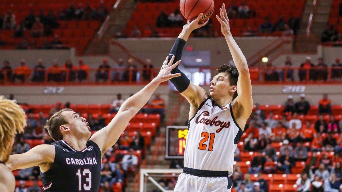 Oklahoma State’s Lindy Waters shoots a 3-point shot over South Carolina’s Felipe Haase during an NCAA college basketball game, Saturday, Jan. 26, 2019, in Stillwater, Okla. (Devin Lawrence Wilber/Tulsa World via AP)