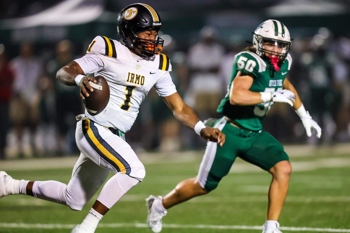 Irmo Yellow Jackets quarterback Aaron (AJ) Brand (1) scrambles during their game at Dutch Fork High School, 11/8/24.