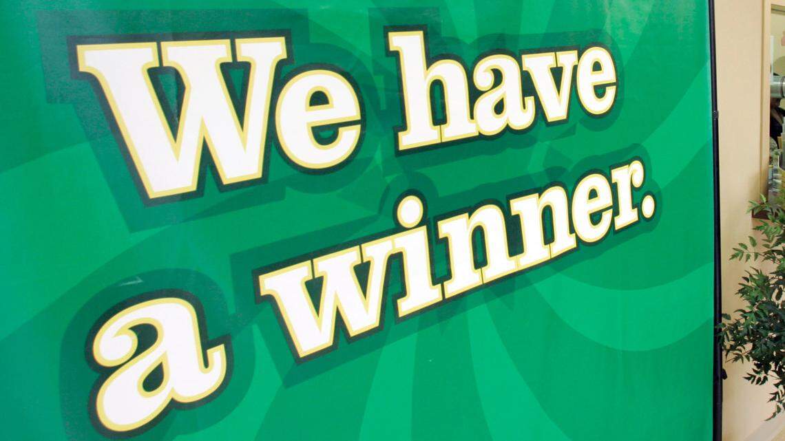 The mom checked with her son and sister-in-law to make sure she won, lottery officials said. (AP Photo/Chuck Burton)