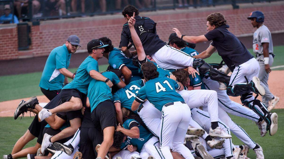 Coastal Carolina players dogpile after winning the Auburn Super Regional to advance to the 2025 College World Series.