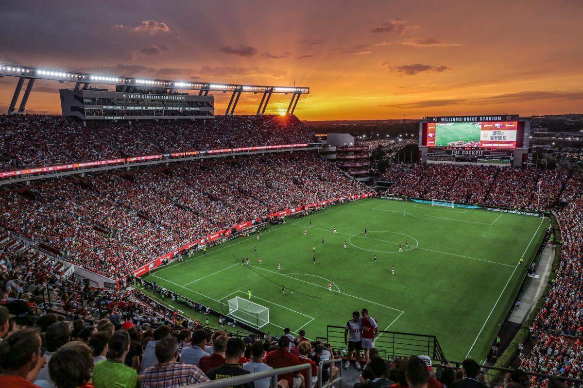 The sun sets over Williams-Brice Stadium as soccer fans watch the Premier League soccer match between Manchester United and Liverpool on Saturday, Aug. 3, 2024.