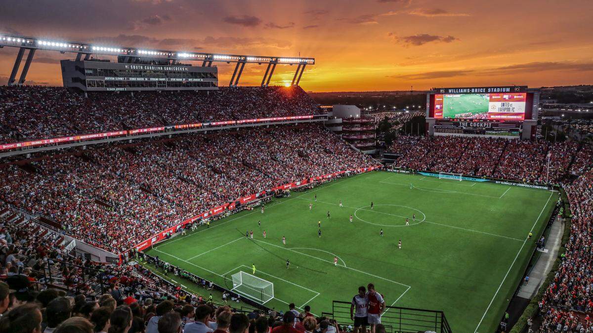 The sun sets over Williams-Brice Stadium as soccer fans watch the Premier League soccer match between Manchester United and Liverpool on Saturday, Aug. 3, 2024.