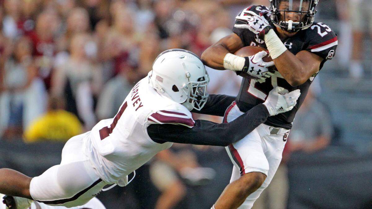 South Carolina Gamecocks running back A.J. Turner (25) tries to get past Texas A&M Aggies defensive back Nick Harvey (1) in 2016. Now Harvey will be a Gamecock.
