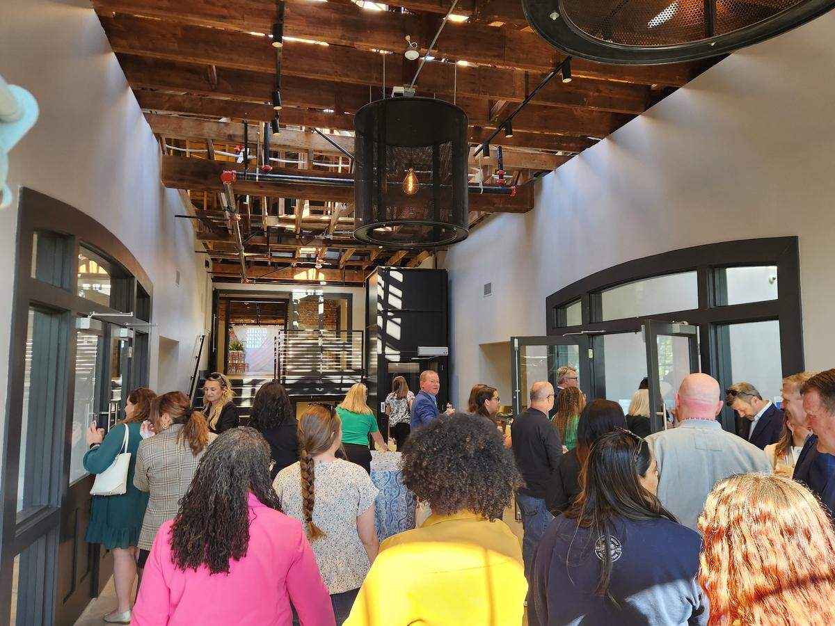 People gather on April 9, 2025 at the grand opening of The Laundry, a new event space venue in the BullStreet District.