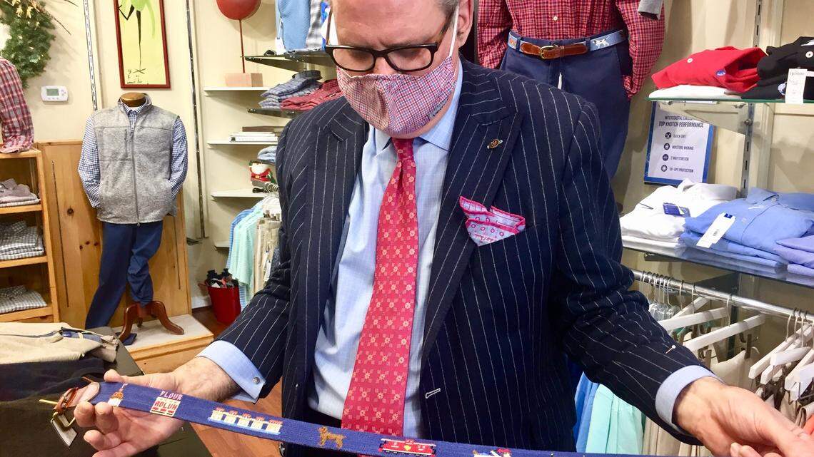 Brittons of Columbia store manager Perry Lancaster holds a handcrafted Smathers & Branson belt featuring icons of Columbia, including the Adluh Flour mill, Gervais Street bridge and the cowboy in a bathtub from the former Yesterdays restaurant.