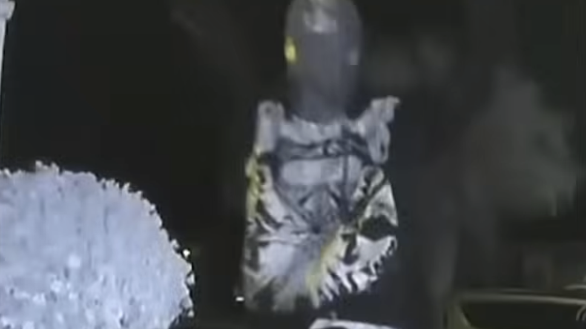 A thief is shown trying to get a signal from a key fob.