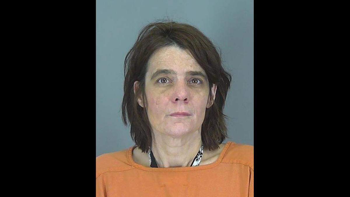 Daisy Ann Anderson was arrested after five of her dogs attacked a woman attending a funeral, officials said.