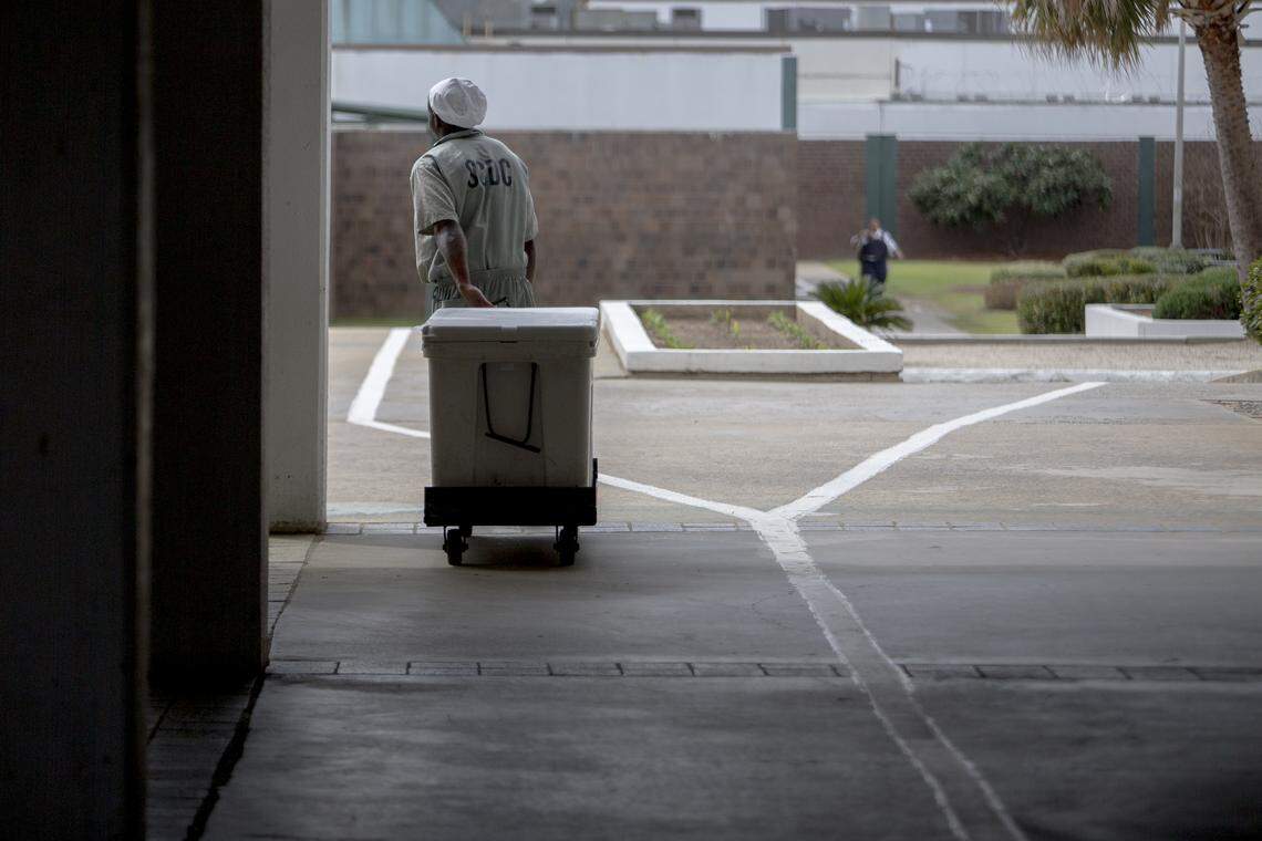 An SCDC inmate pulls a cart across the yard at Kirkland Correctional Institution Thursday March 14, 2019, in Columbia, SC.