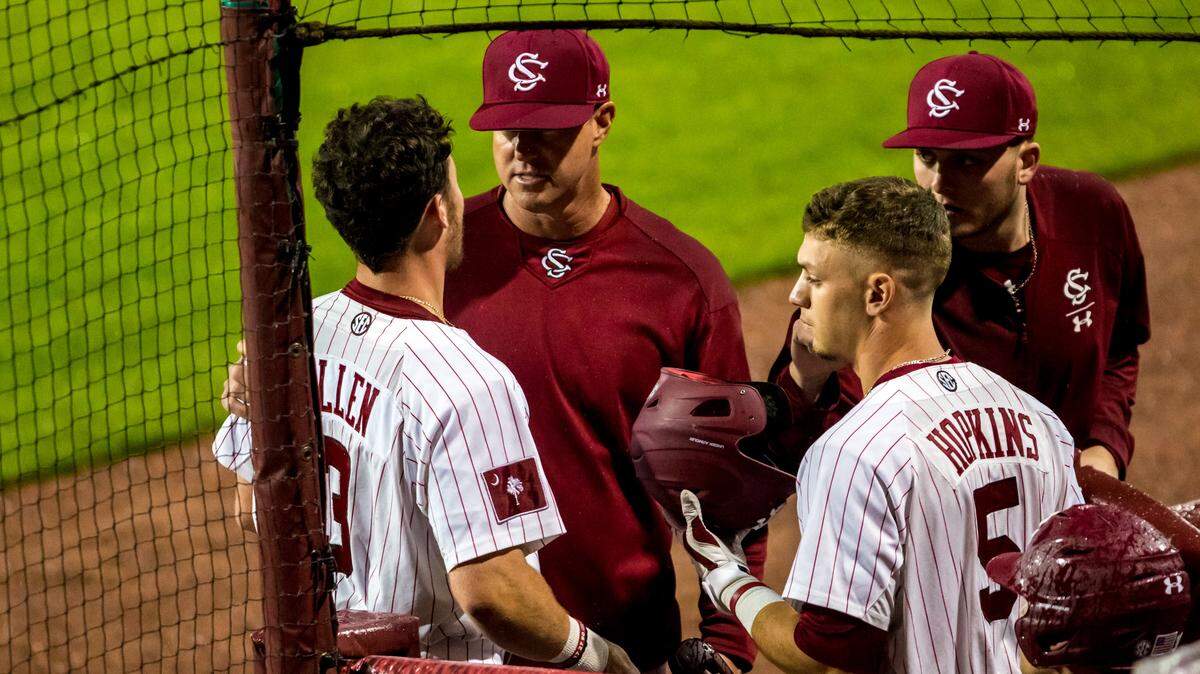 South Carolina Gamecocks head coach Mark Kingston talks with South Carolina Gamecocks outfielder Brady Allen (3) and South Carolina Gamecocks outfielder TJ Hopkins (5) against the Valporaiso Crusaders.