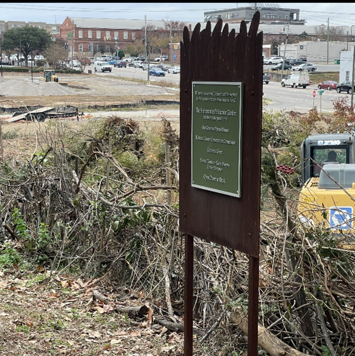 A sign marks the location of a once vibrant pollinator garden at Stormwater Studios in Columbia. The garden was damaged when trees were cleared for a hotel project next door. The clearing took away a lush buffer between the art studio and the construction site. This photo was taken in December 2024.