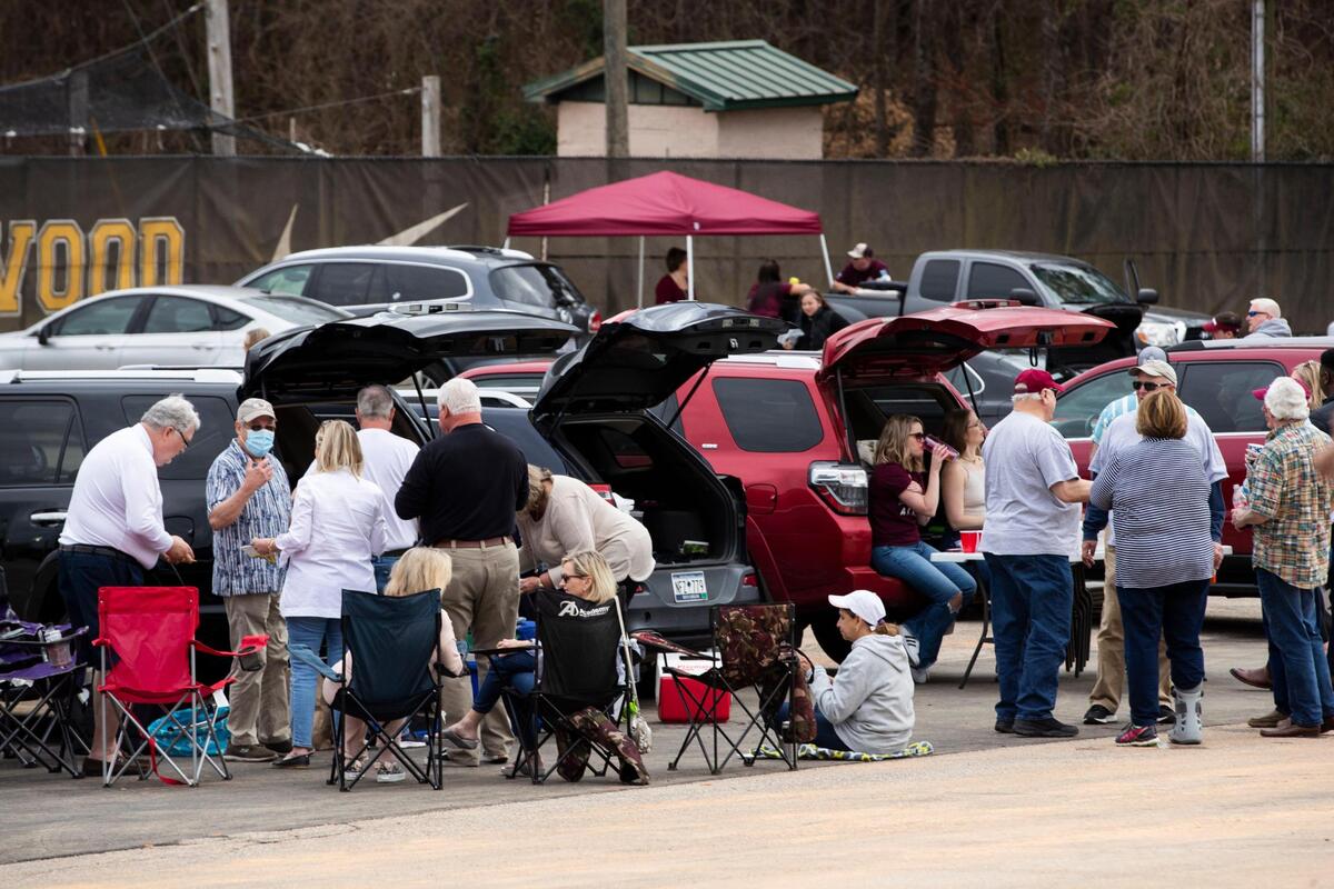 A group of alumni and their families from across the state tailgate before Erskine College plays Shorter University on Saturday, March 13, 2021.