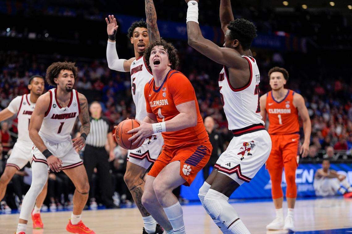 Clemson Tigers forward Ian Schieffelin (4) looks for the put back score against Louisville Cardinals forward Aboubacar Traore (25) the Louisville Cardinals during the first half at Spectrum Center.