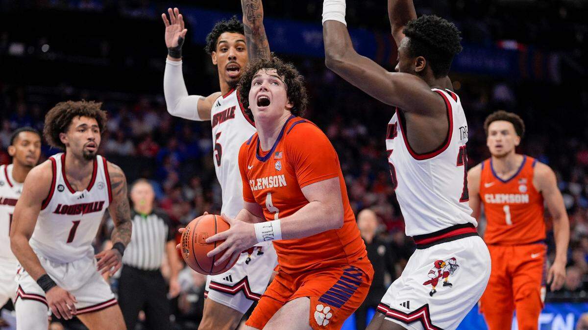 Clemson Tigers forward Ian Schieffelin (4) looks for the put back score against Louisville Cardinals forward Aboubacar Traore (25) the Louisville Cardinals during the first half at Spectrum Center.