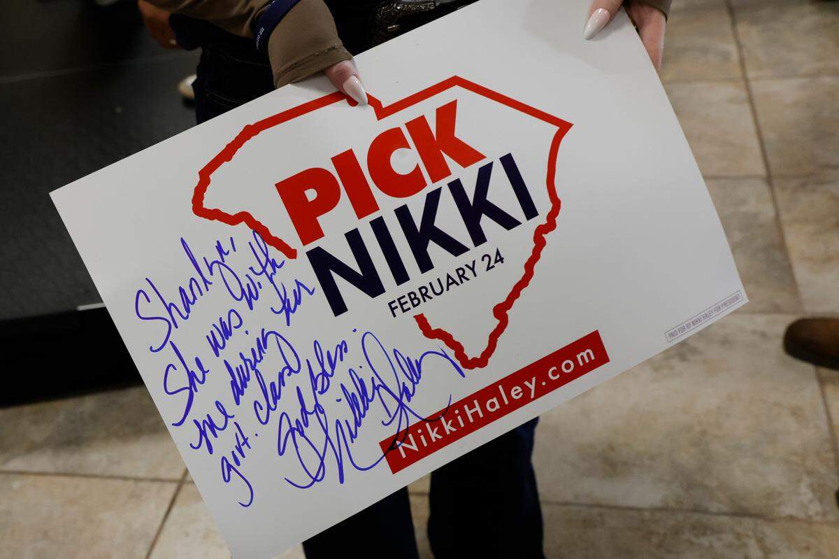 Candidate fort U.S. President, Nikki Haley signed a poster for Shanlyn Todd during a campaign rally at Thunder Tower Harley Davidson in Pontiac on Monday, Feb. 12, 2024. The note on the poster was an excuse for Shanlyn missing government class to attend the rally.