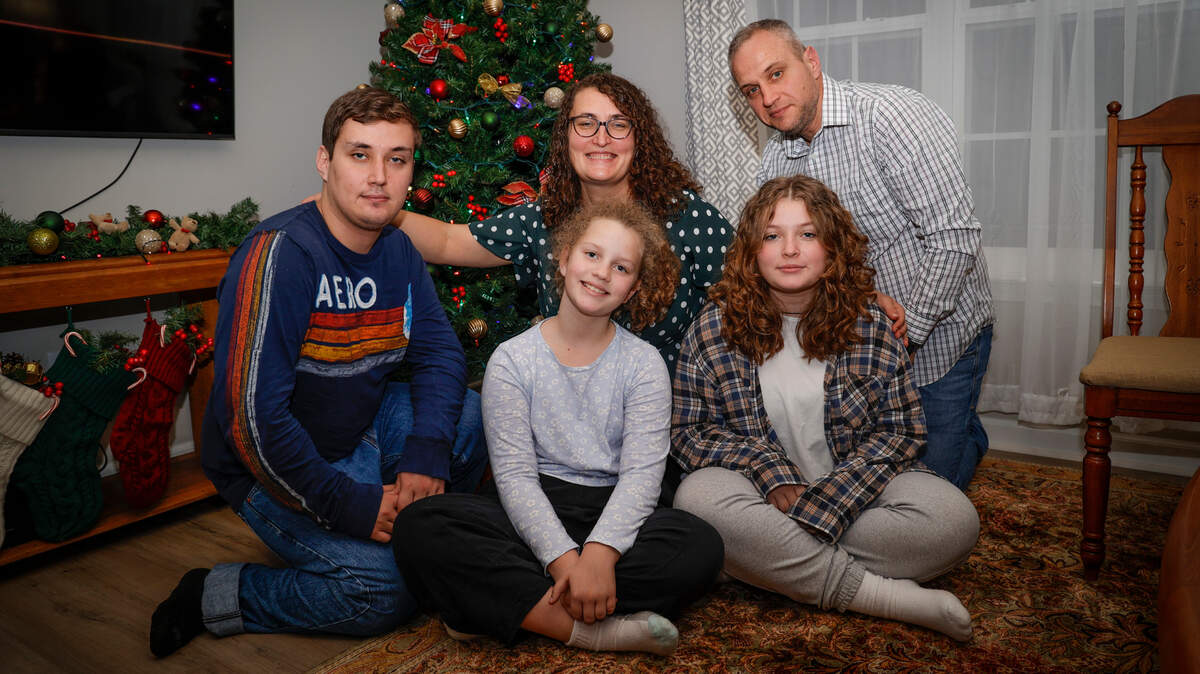 Alex and Olga Mazur pose for a portrait with their children, Illia, 21, Vicki, 10, and Kate, 16, at their house in Chapin. The Mazurs fled Ukraine in mid August.