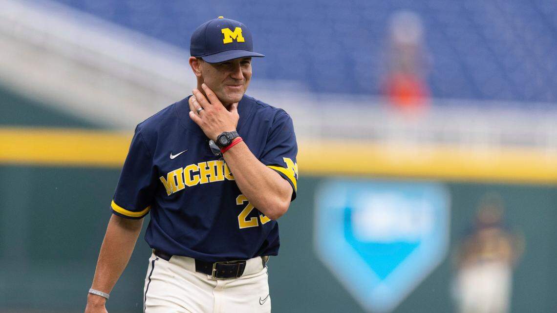 Michigan head coach Erik Bakich returns to the dugout following a meeting on the mound in the first inning against Rutgers in the NCAA college Big Ten baseball championship game Sunday, May 29, 2022, at Charles Schwab Field in Omaha, Neb. Michigan defeated Rutgers 10-4. (AP Photo/Rebecca S. Gratz)