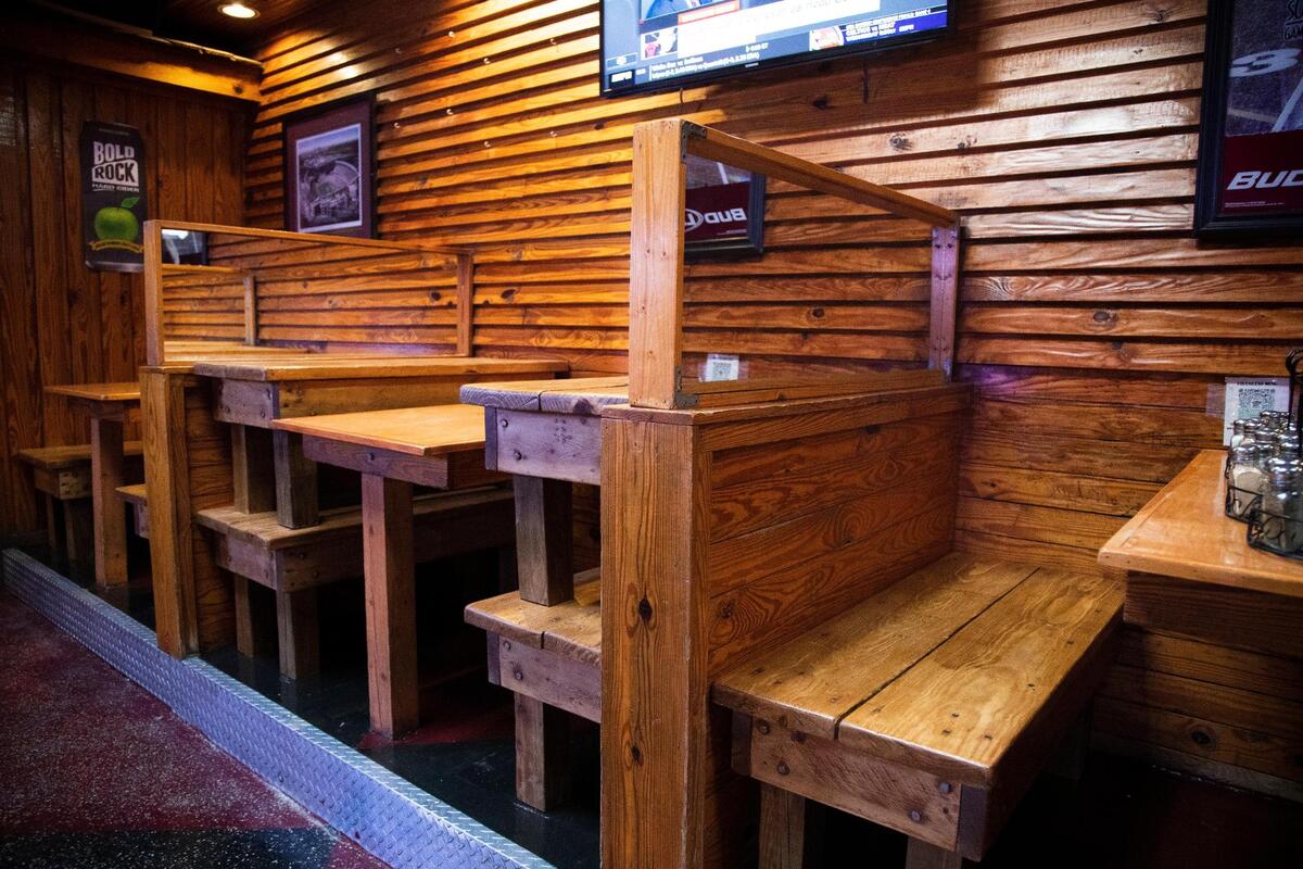 Benches are stacked on top of one another to prevent people from sitting in them at Village Idiot on Tuesday, September 22, 2020. The restaurant is celebrating 30 years of serving pizza in Five Points while also adapting to the coronavirus.