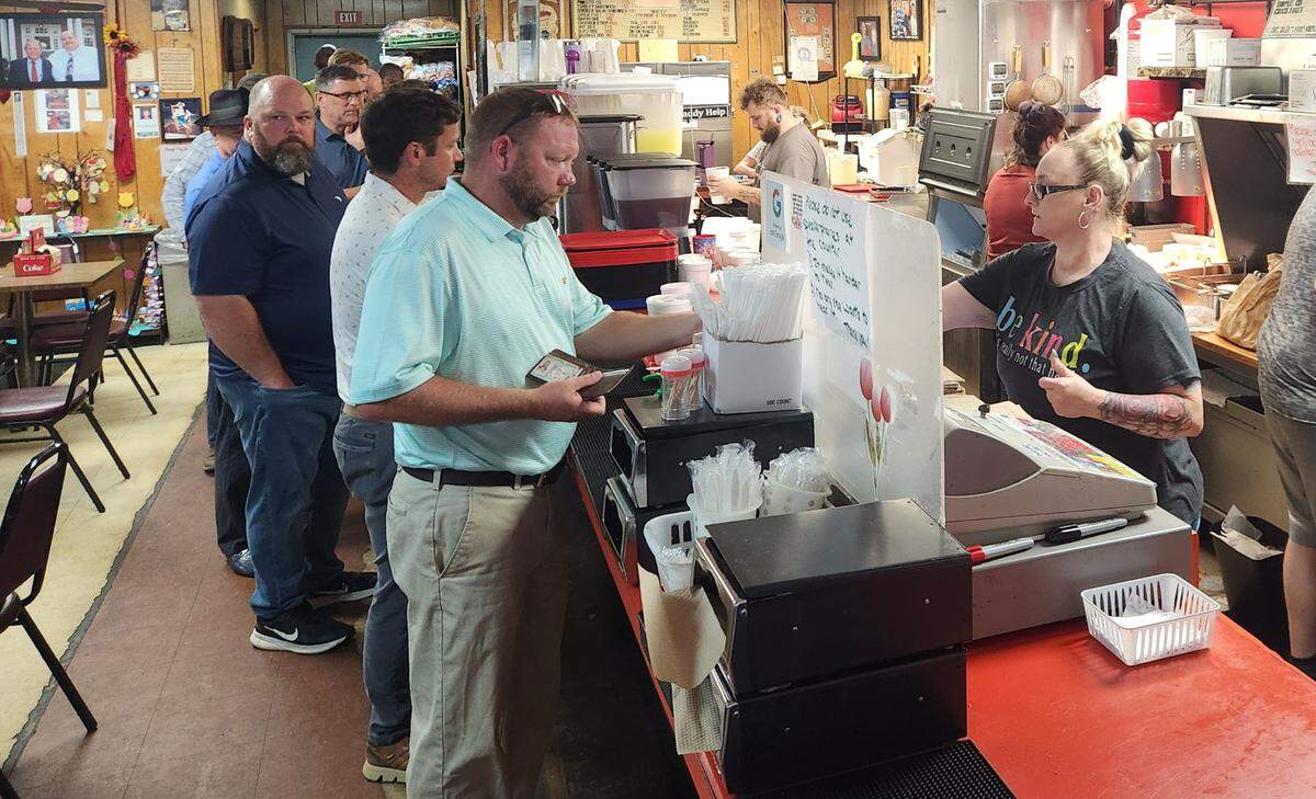 Folks line up for lunch at Mack’s Cash Grocery on Laurel Street in Columbia on July 16, 2025.