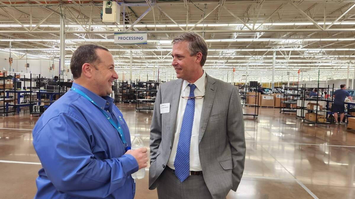 EPC, Inc. President Pat Laughlin, left, and Columbia Mayor Daniel Rickenmann chat on June 6 at EPC’s facility on Bush River Road.
