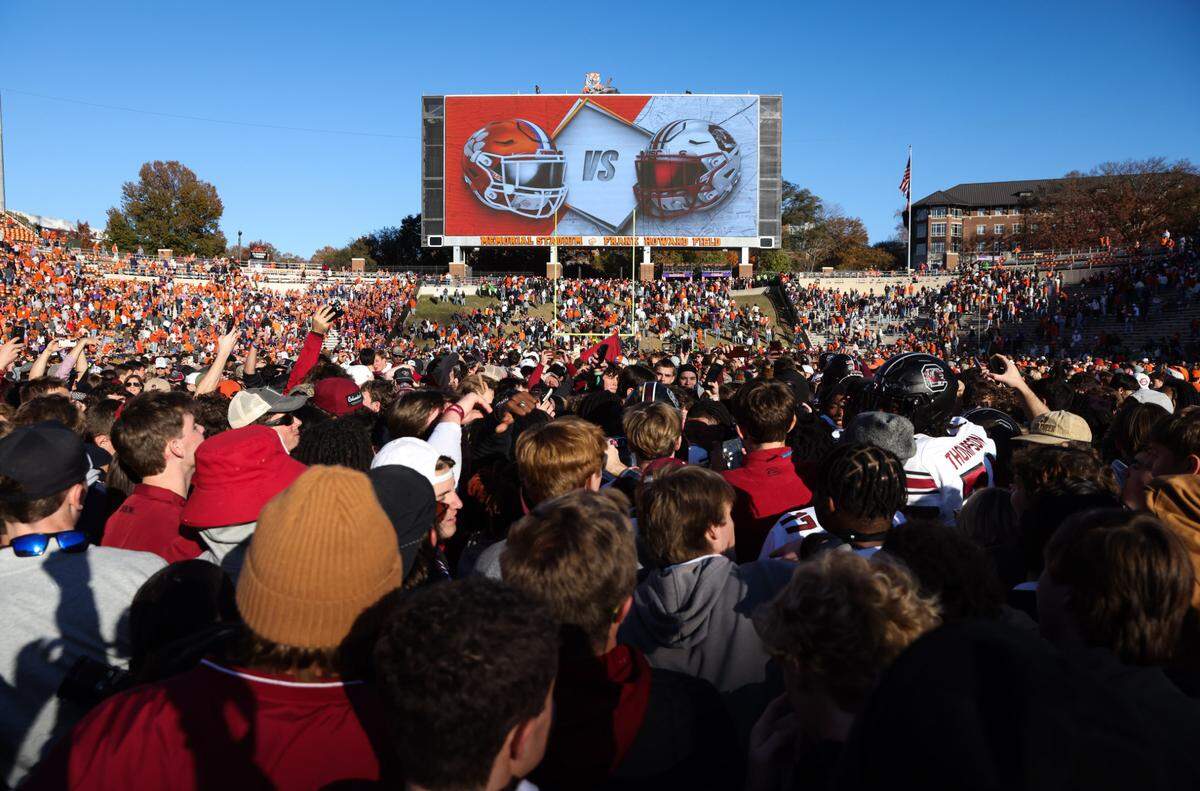 South Carolina fans celebrate with players after defeating Clemson in the Palmetto Bowl between at Memorial Stadium in Clemson on Saturday, November 30, 2024.