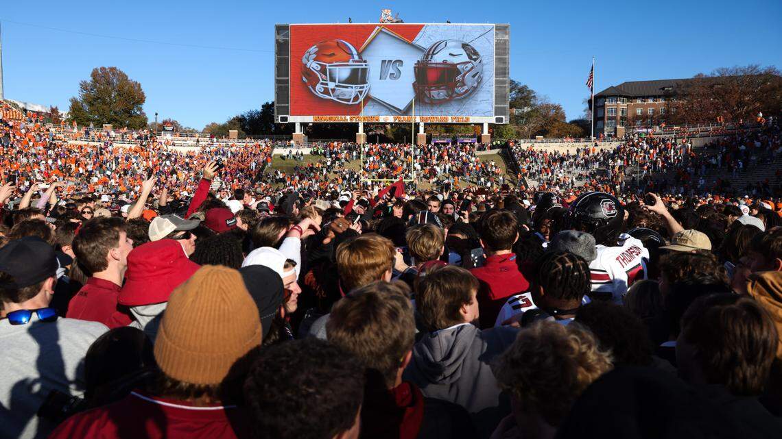 South Carolina fans celebrate with players after defeating Clemson in the Palmetto Bowl at Memorial Stadium in Clemson on Saturday, November 30, 2024.